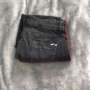 Black jeans with red stripes